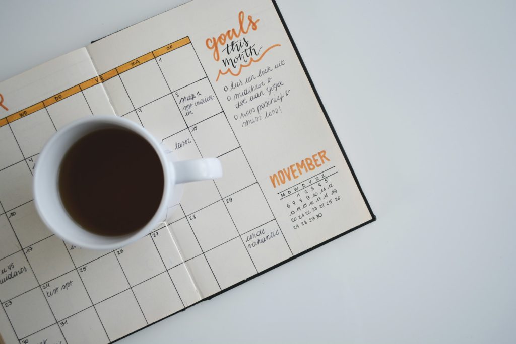 A coffee mug on a planner.